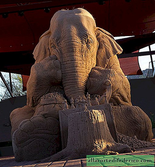 Life-conquering sand sculpture of a life-sized elephant playing chess with a mouse